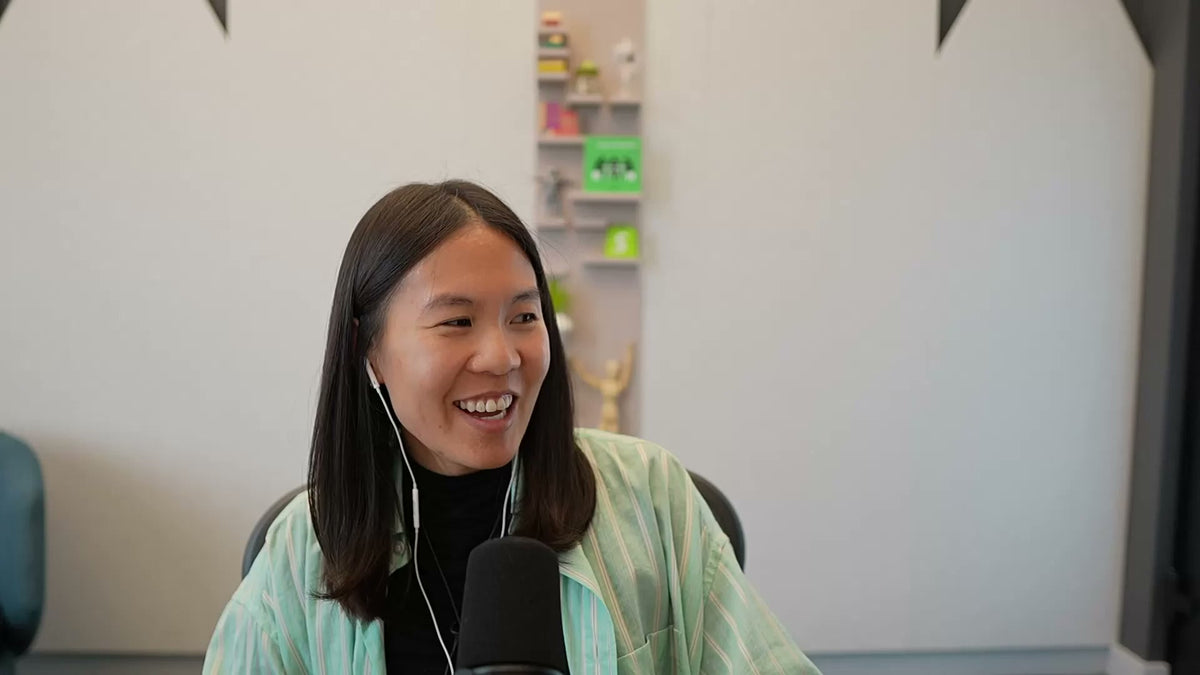 Vanessa Lee, VP of Product at Shopify, smiling at a podcast microphone during an interview about Shopify Editions Fall 2026